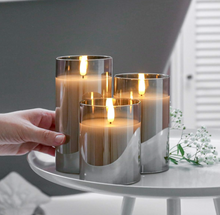 Festive Lights - 3 Pack of Grey LED Real Wax Candles in Smoked Glass Cylinder - Authentic Flickering Flame on Realistic Black Wick - Battery Operated with Time (With Remote)